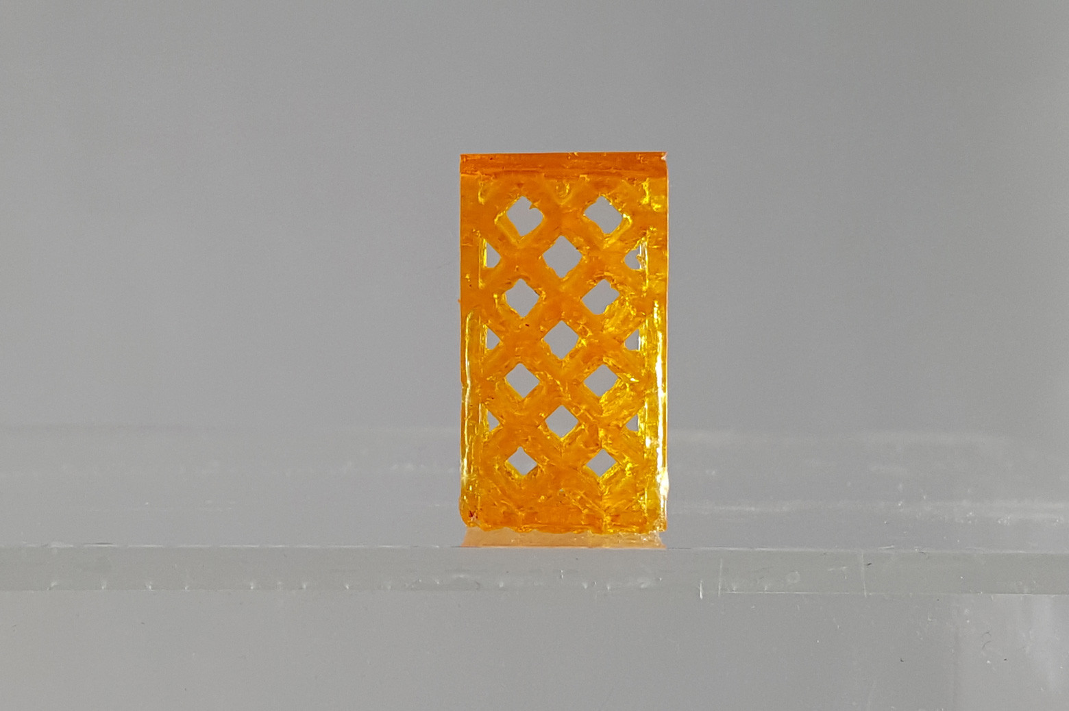 Close-up view of a resin sample produced with the University of Michigan's advanced 3D printer, highlighting the precision and detail achievable.